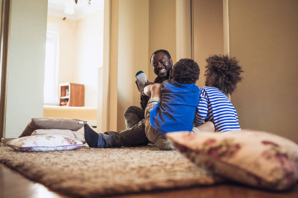 istock Kids having fun at home, playing with their father 1002107442