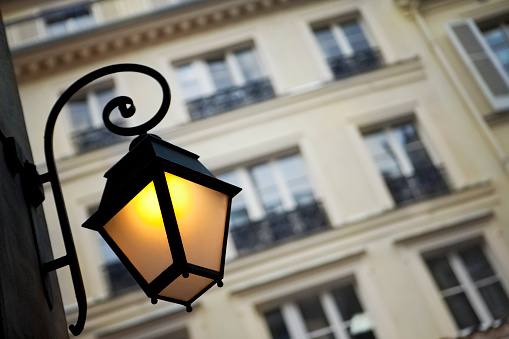 Vintage street lamp and typical facade in Paris