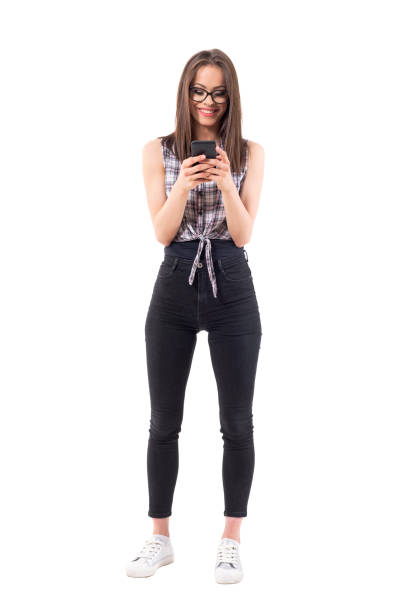 istock Happy relaxed smiling modern style hipster girl using mobile phone 1002112638