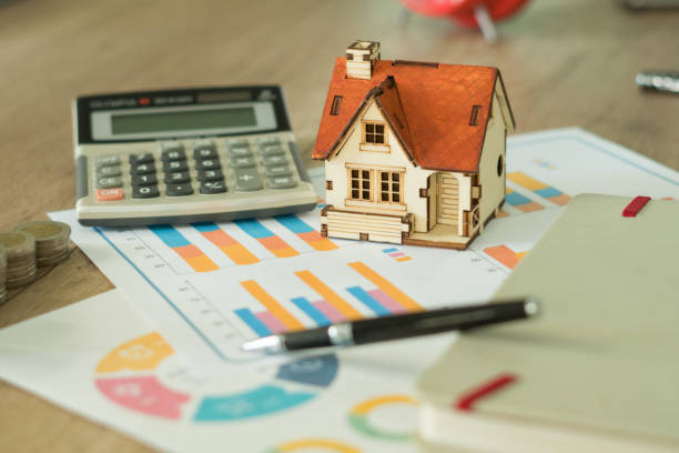 istock Financial paper and work station and house model with tablet on working table, business concept. 1002113522