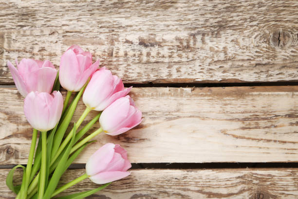 istock Bouquet of tulips on grey wooden table 1002113802
