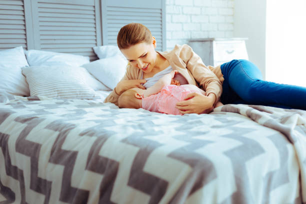istock Positive delighted woman feeding her daughter 1002114382