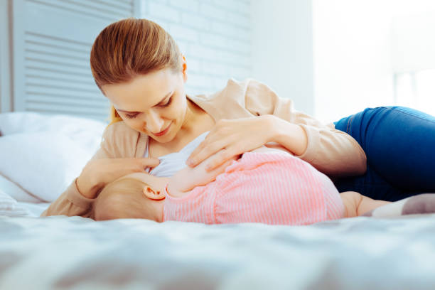 istock Attentive female person nursing her baby 1002114554