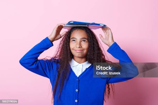 Portrait Of Cute Afro Amercian Schoolgirl Stock Photo - Download Image Now - Looking Up, High School Student, Child
