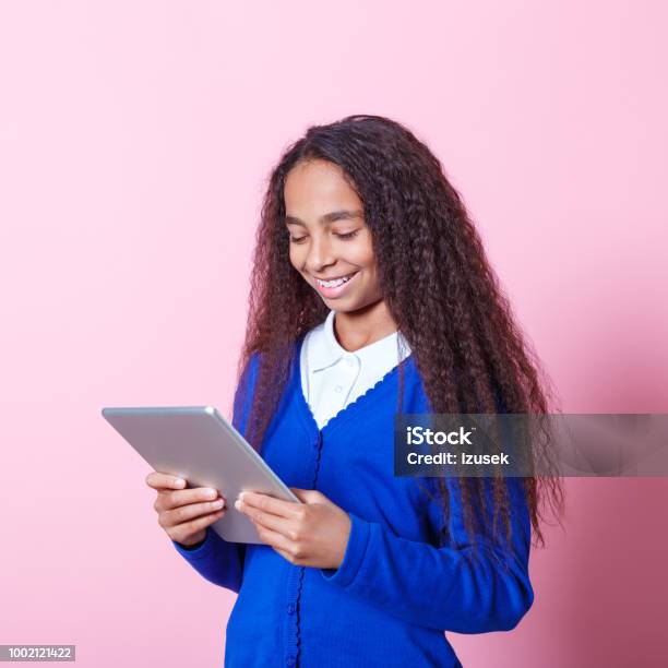 Portrait Of Happy Afro Amercian Schoolgirl Using Digital Tablet Stock Photo - Download Image Now
