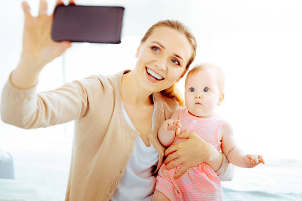 istock Happy young mother doing photo 1002127938