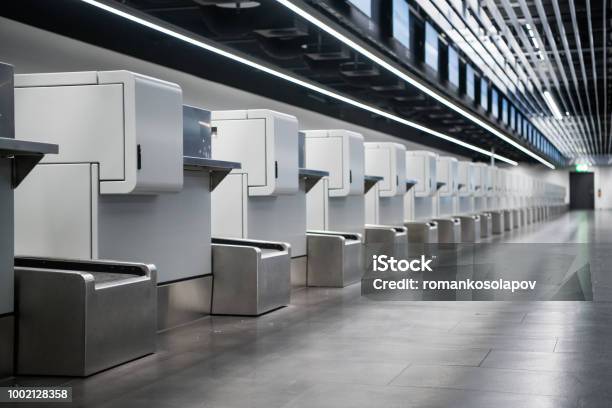 Interior Of Checkin Area In Modern Airport Luggage Accept Terminals With Baggage Handling Belt Conveyor Systems Multiple Information Lcd Screen Indexed Checkin Desks Stock Photo - Download Image Now
