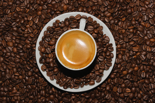 cup of hot coffee on white background and coffee beans