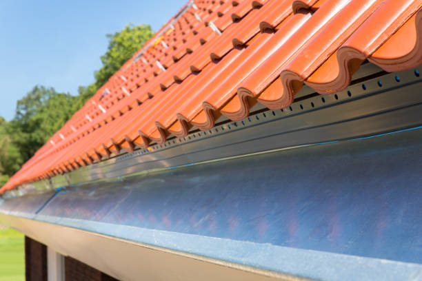 istock Close up new gutter with roof tiles 1002132058