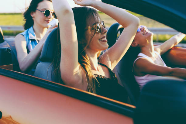 istock Young women on a road trip with cabriolet 1002132376