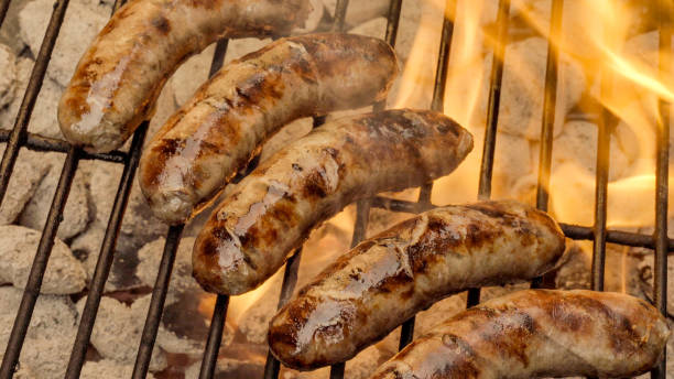 istock Bratwurst on a Fiery Hot Charcoal Grill 1002135340