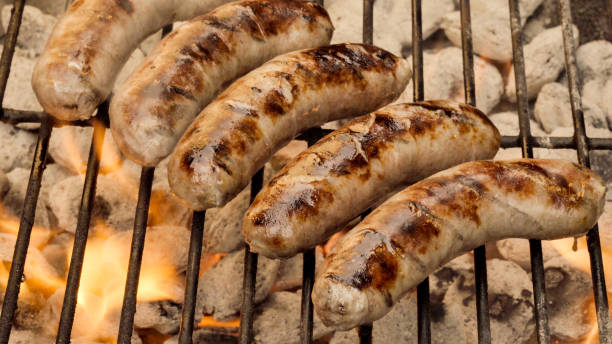 istock Bratwurst on a Fiery Hot Charcoal Grill 1002135464