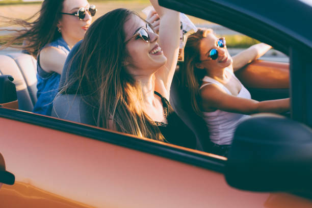 istock Young women on a road trip with cabriolet 1002135722