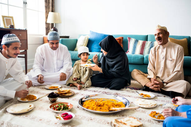istock Muslim family having dinner on the floor 1002140838