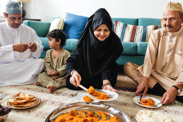 istock Muslim family having dinner on the floor 1002141502