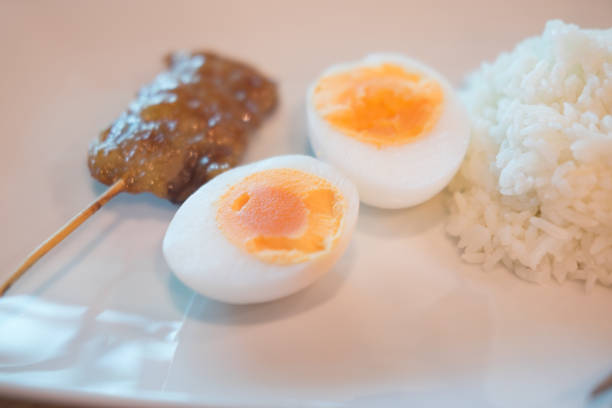 istock Grilled skewered pork and boiled egg served with cooked Jasmine rice in dish 1002143210