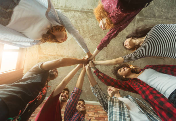 istock Group of friends holding hands together 1002144400