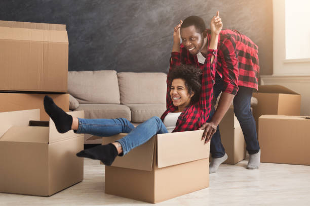 istock Young black couple unpacking moving boxes 1002144508