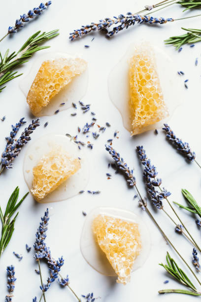 istock elevated view of honeycombs, lavender and rosemary on white table 1002145342