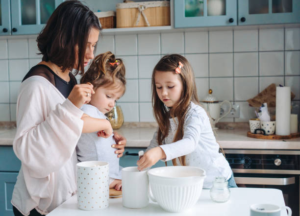 istock Happy family cook together in the kitchen 1002149582