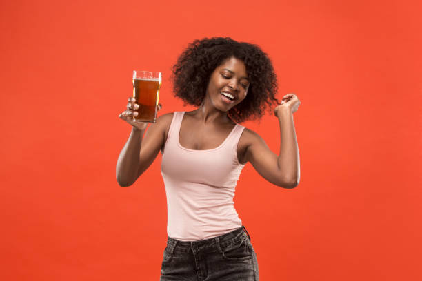 istock Young afro woman drinking beer, not isolated on white background 1002149664