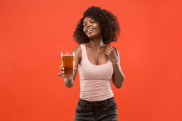 istock Young afro woman drinking beer, not isolated on white background 1002149716