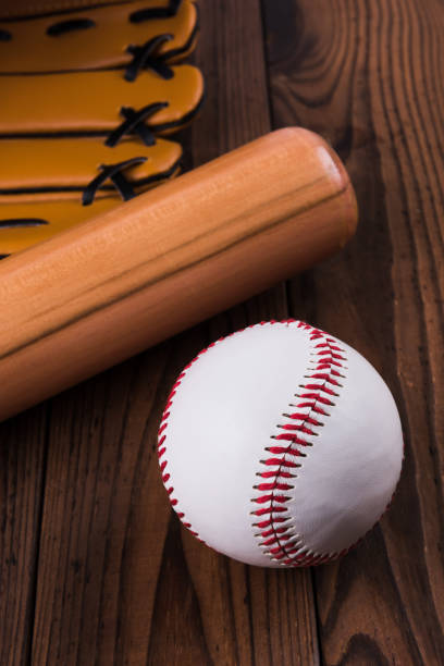istock Baseball bat, ball and glove wooden table. Closeup 1002149932