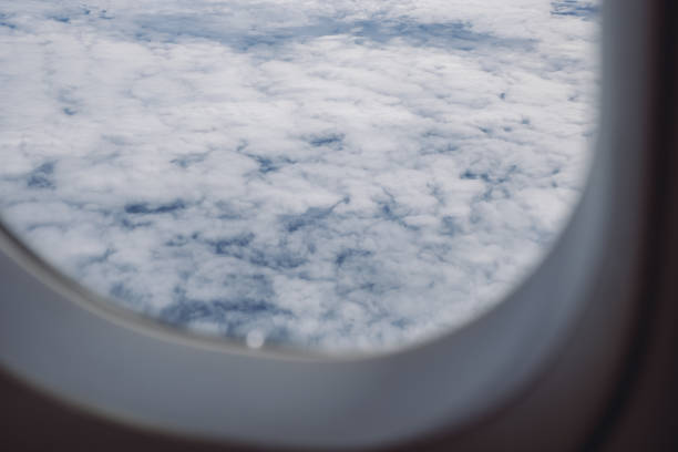 istock The blue sky on cloudy day through an airplane window 1002157922