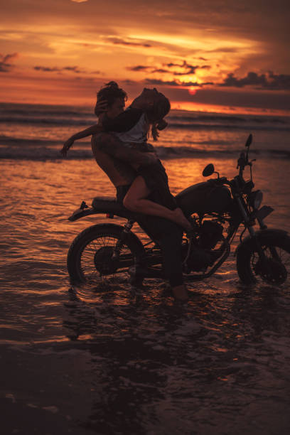 istock sexy boyfriend and girlfriend hugging on motorcycle at beach during sunset 1002158132