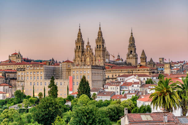 Hazy sunset on Santiago de Compostela cathedral and city view. Hazy sunset on monumental Santiago de Compostela cathedral and cityscape. pilgrimage photos stock pictures, royalty-free photos & images