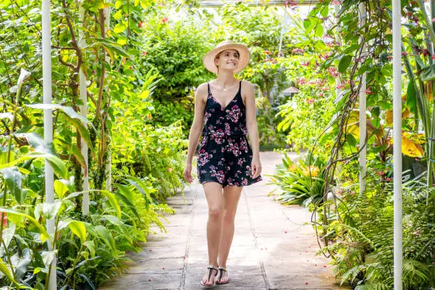 Photo of Woman visiting in tropical garden
