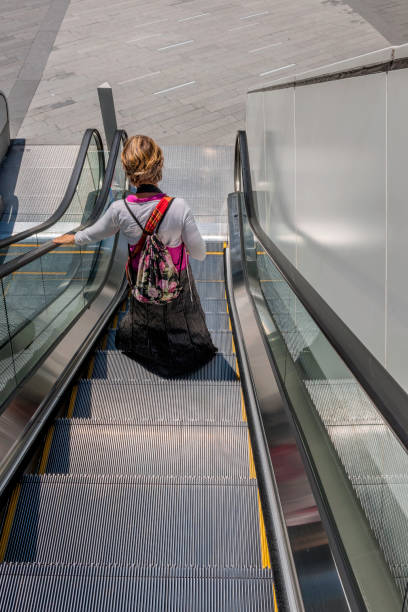 istock Woman on Escalator, Beijing, China, Asia 1002168280