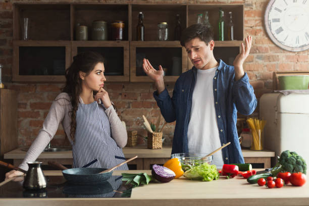istock Couple cooking healthy dinner together 1002175630