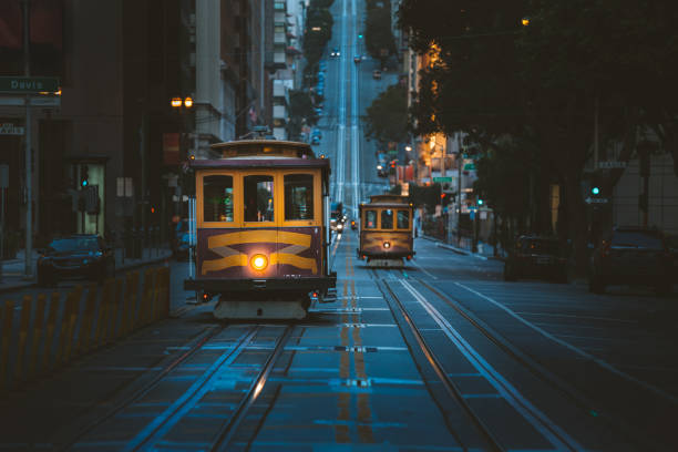 Historic San Francisco Cable Cars on famous California Street at twilight, California, USA Magical twilight view of historic Cable Cars riding on famous California Street at dawn before sunrise, San Francisco, California, USA fishermans wharf san francisco photos stock pictures, royalty-free photos & images