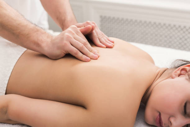 istock Closeup of hands massaging female shoulders and back 1002179174