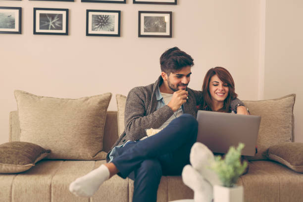 istock Couple reading news on laptop 1002181252