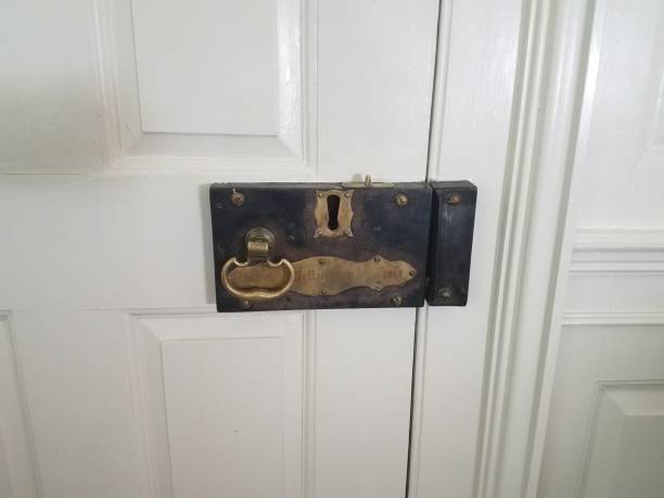 very old metal lock on white door