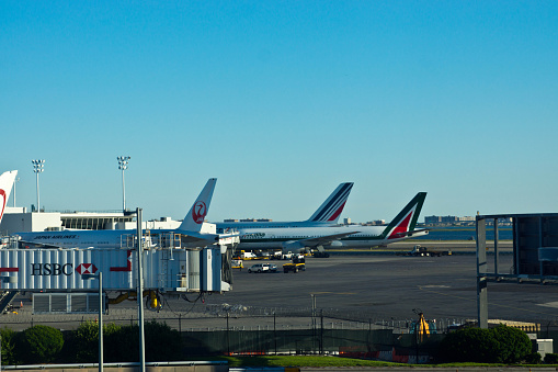The Airline taxi way and hard standing at New York JFK International Airport as seen from the subway approaching the airport. This includes Air Italia, Japan airlines and others.