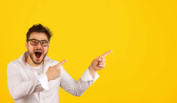 istock Hipster man pointing away with excitement 1002197174