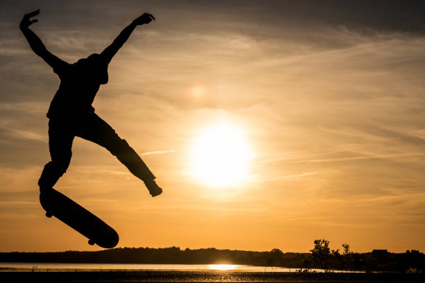 istock Skater jump against the beautiful orange sunset 1002201490