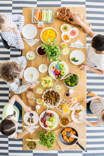 istock Top view on children eating dinner during birthday party at home 1002210024