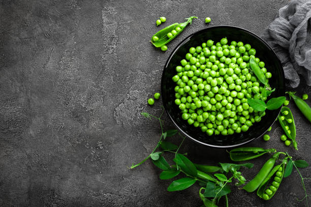 Green peas with pods and leaves Green peas with pods and leaves green pea photos stock pictures, royalty-free photos & images