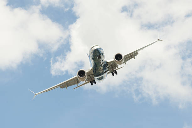 Boeing 737 MAX Farnborough, UK - July 16, 2018: Boeing 737 MAX on a steep angled landing descent to Farnborough Airport, UK airshow photos stock pictures, royalty-free photos & images