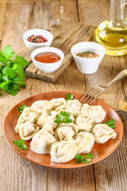 istock Homemade ready dumplings on an old wooden table. 1002216574