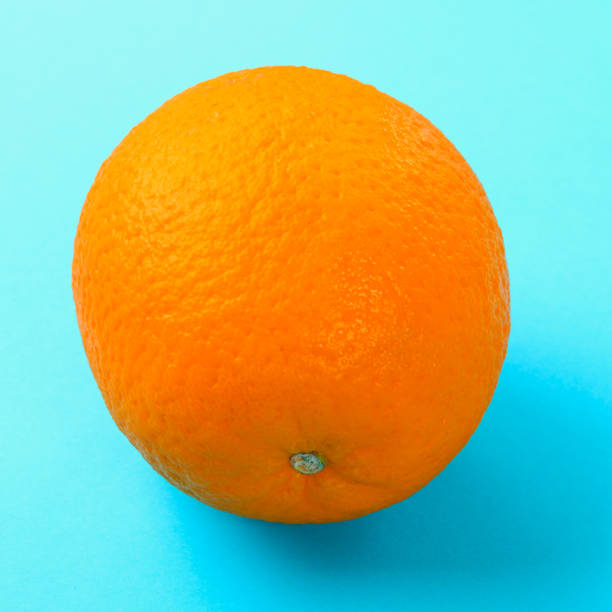 istock Orange whole orange on pastel blue background. 1002216782
