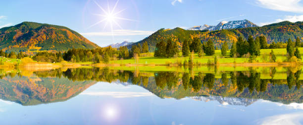 istock Panoramic scene in Bavaria with alps mountains mirroring in lake 1002226908