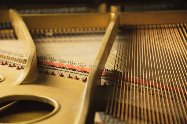 The inside of a classical  grand piano instrument with copper cord strings. stock photo