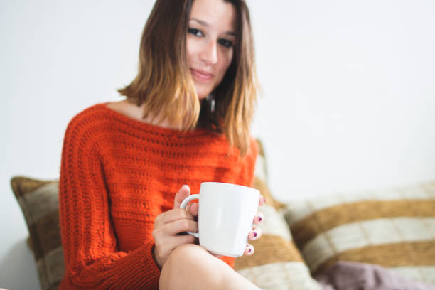 istock Young caucasian cute girl drinking coffee in her bed 1002232576