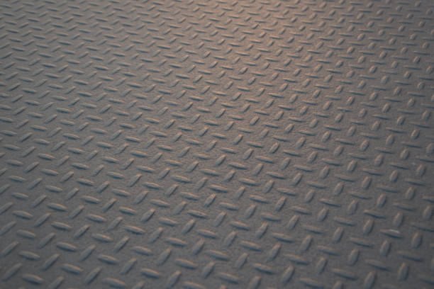 istock Old worn checkerplate grungy industrial wallpaper or background 1002232640