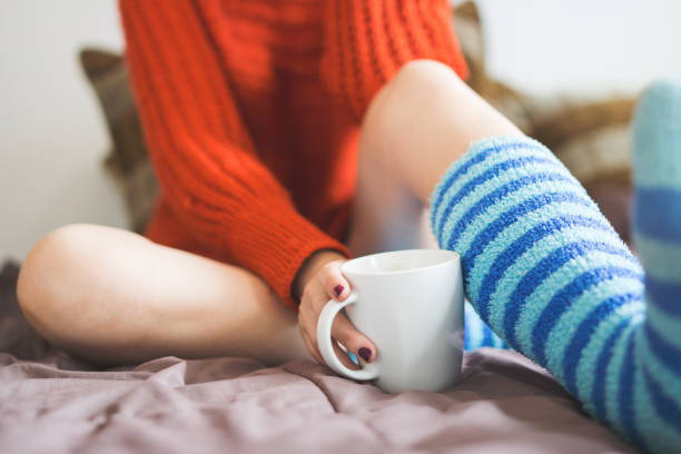 istock Young caucasian cute girl drinking coffee in her bed 1002233032